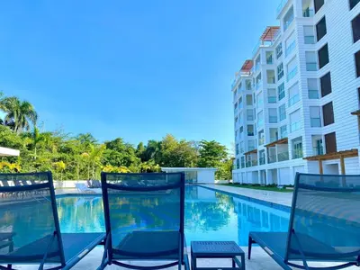 two chairs sitting next to a swimming pool at Escape-Fortunity 1 in San Felipe de Puerto Plata