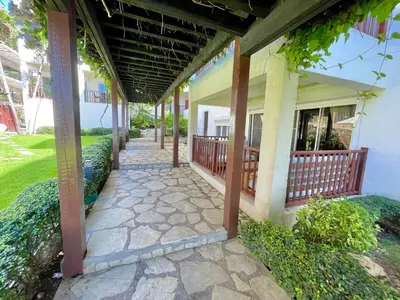 a walkway outside of a building with a porch at Spacious apartment beach access in Juan Dolio