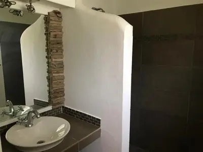 a bathroom with a sink and a shower at Villa Bianca - BEACHFRONT with Pool in Sosúa