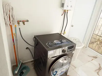 a washer and dryer in a corner of a room at APE Dream Villa in Itabo