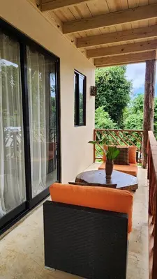 a screened in porch with a table and chairs at Boho villas and spa in El Valle