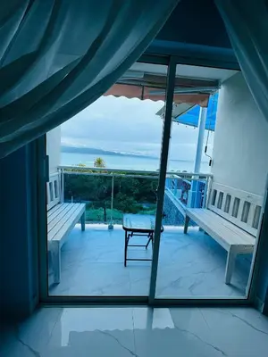 a room with a balcony with a view of the ocean at Sundown Relaxed in Punta Rucia