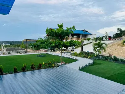 a walkway in a park with a house in the background at Sundown Relaxed in Punta Rucia