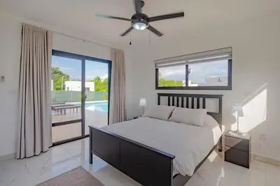 a bedroom with a bed and a ceiling fan at Beautiful villa in the Caribbean! in Sosúa