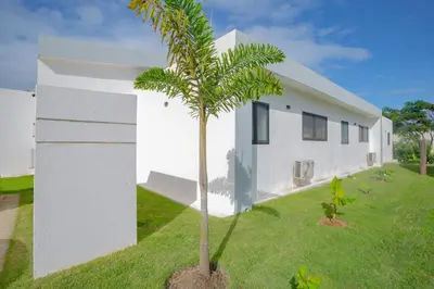 a palm tree in front of a white building at Beautiful villa in the Caribbean! in Sosúa