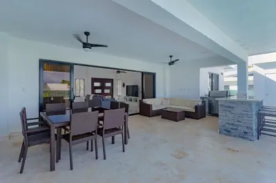a living room with a table and chairs and a couch at Beautiful villa in the Caribbean! in Sosúa