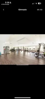 a gym with several treadmills and chairs in a room at Acogedor Apartamento con Vista al mar in Juan Dolio