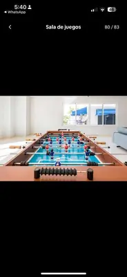 a large room with a pool table with people on it at Acogedor Apartamento con Vista al mar in Juan Dolio