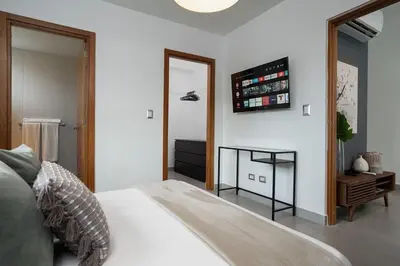 a bedroom with a white bed and a mirror at Armonia 30 suites by Yellowkey in Los Prados