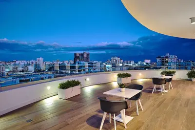 a balcony with a view of a city at night at Armonia 30 suites by Yellowkey in Los Prados