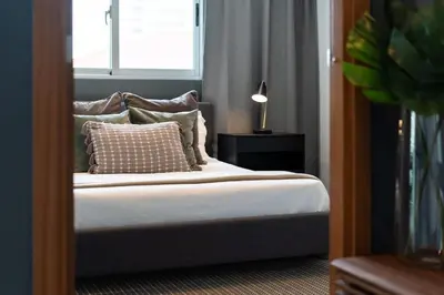 a bedroom with a bed with pillows and a window at Armonia 30 suites by Yellowkey in Los Prados