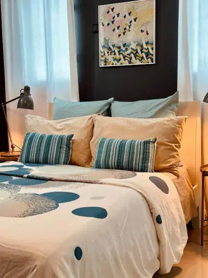 a bed with two pillows on it in a bedroom at Acogedor Penthouse de 2 habitación in Santiago de los Caballeros
