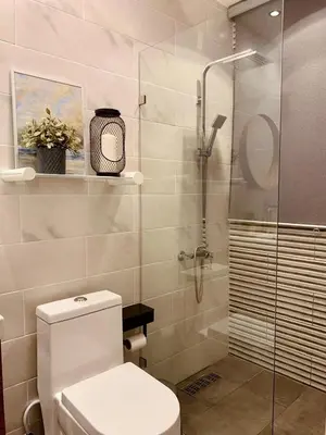 a bathroom with a toilet and a glass shower at Acogedor Penthouse de 2 habitación in Santiago de los Caballeros