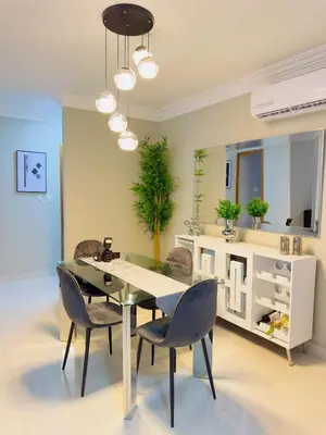 a dining room with a glass table and chairs at Excelente Apartamento Completo Renta Carro Disponible in La Viva