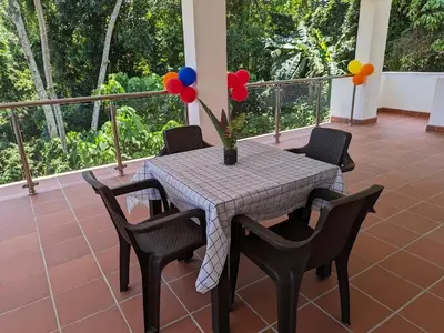 a table with balloons and chairs on a porch at Spacious Apartment w Pool in Las Terrenas