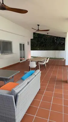 a living room with a couch and a table and chairs at Spacious Apartment w Pool in Las Terrenas