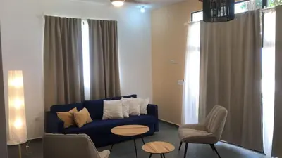 a living room with a blue couch and chairs at Casa Playa Rincon Hills Samana Las Galeras by BTC Group Crypto in Castellalito