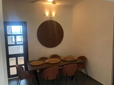a dining room with a table with chairs and a mirror at Casa Playa Rincon Hills Samana Las Galeras by BTC Group Crypto in Castellalito