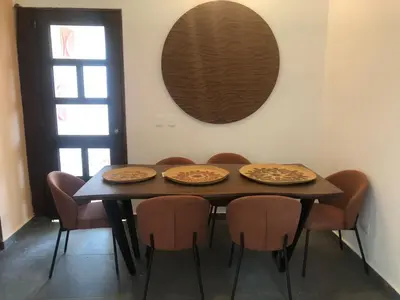 a dining room table with four chairs and a mirror at Casa Playa Rincon Hills Samana Las Galeras by BTC Group Crypto in Castellalito