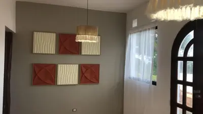 a room with paintings on the wall and a chandelier at Casa Playa Rincon Hills Samana Las Galeras by BTC Group Crypto in Castellalito