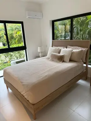 a large bed in a bedroom with two windows at Cocotal 2beds apartament Golf Course Melia Beach PC RD in Punta Cana