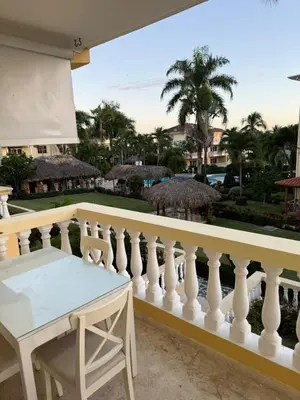 a balcony with a white railing and a table at Boca chica retreat in Boca Chica