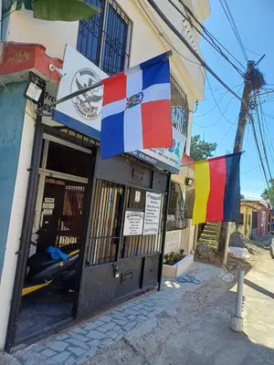 a building with flags hanging outside of it at Dona Beba Guesthouse in La Caleta