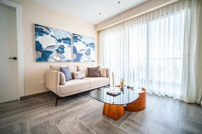 a living room with a couch and a table at Aston Rubi City Suites in Santo Domingo