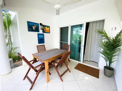 a dining room table and chairs on a patio at Gorgeous apartment steps to Playa Punta Popy in Las Terrenas