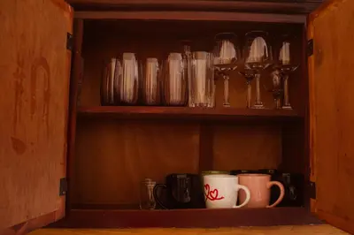 a cupboard filled with lots of glasses and mugs at Residencial A&H in Boca Chica
