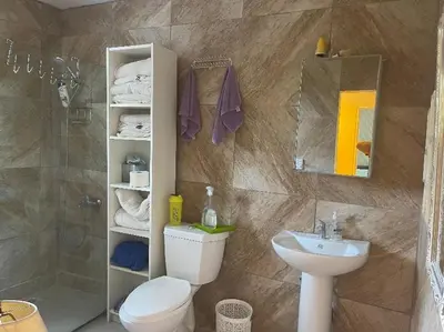 a bathroom with a toilet and a sink and a shower at Villa Tulum in San Cristóbal