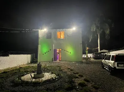 a house with green lights on the side of it at Villa Tulum in San Cristóbal