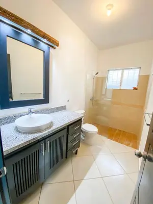 a bathroom with a sink and a toilet and a mirror at la fenice un apartamento de ensueño en Las Terrenas playa Punta Popy in Las Terrenas
