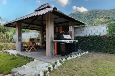 a gazebo with a grill in a yard at Rancho Don Pedro in Bonao