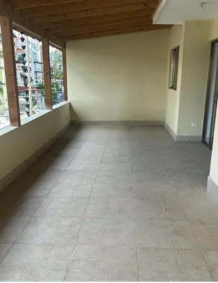 an empty room with windows and a tiled floor at Tu guarida in Santo Domingo