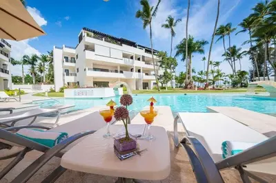 a table with drinks on it next to a swimming pool at Aligio - A Quiet Retreat in Paradise - 2 BR, 2 pools, WiFi, AC, Private Hot Tub in Las Terrenas