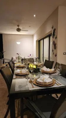 a dining room table with plates and wine glasses at Aligio - A Quiet Retreat in Paradise - 2 BR, 2 pools, WiFi, AC, Private Hot Tub in Las Terrenas