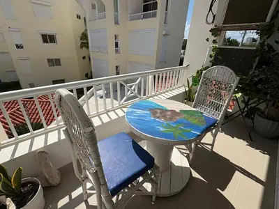 a table and two chairs on a balcony at Albatros Cozy Apt in Juan Dolio