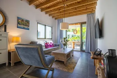 a living room with a couch and a table at ProCab Kaya Apartments Cabarete in Cabarete