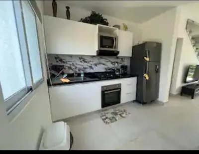 a kitchen with a refrigerator and a microwave at Flamingo Villa in Boca Paraiso in Boca Chica