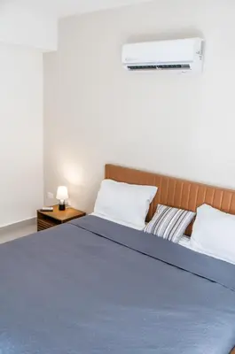 a bedroom with a bed with a blue blanket at Luxury Apartment Rooftop With Two Level and Infinitive Pool in Santiago de los Caballeros