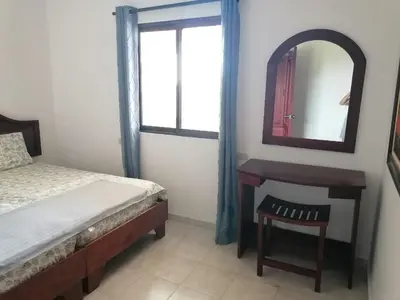 a bedroom with a bed and a mirror and a chair at Apartment Rozarka Soficu El Edén Dominicus in La Laguna