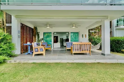 a patio with chairs and a table on it at Oceanfront Apt W- Private Beach - Las Terrenas in El Limón