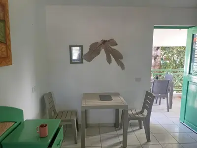 a dining room with a table and chairs at Cozy studio- centre - near beach in Las Terrenas