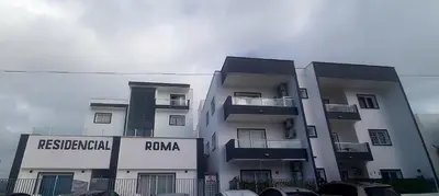 a tall white building with a roma sign on it at LA CASITA de Bayahibe in Bayahibe