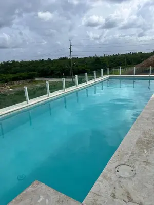 a large swimming pool with blue water at LA CASITA de Bayahibe in Bayahibe