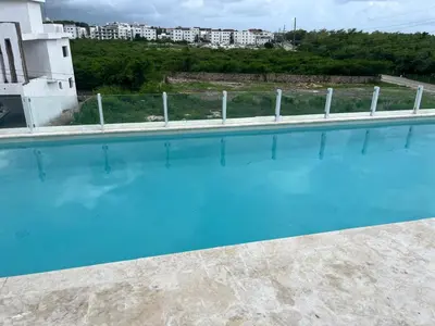 a large swimming pool with blue water at LA CASITA de Bayahibe in Bayahibe