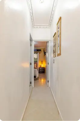 a hallway with white walls and a ceiling at mini apartamento in Colorado