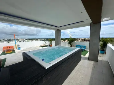 a hot tub on the balcony of a house at Apartamento Santo Domingo este in Juan López