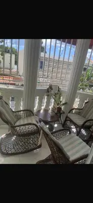 two chairs and a table on a balcony at The Garcias Village C with Jacuzzi ACNetflix in La Alianza